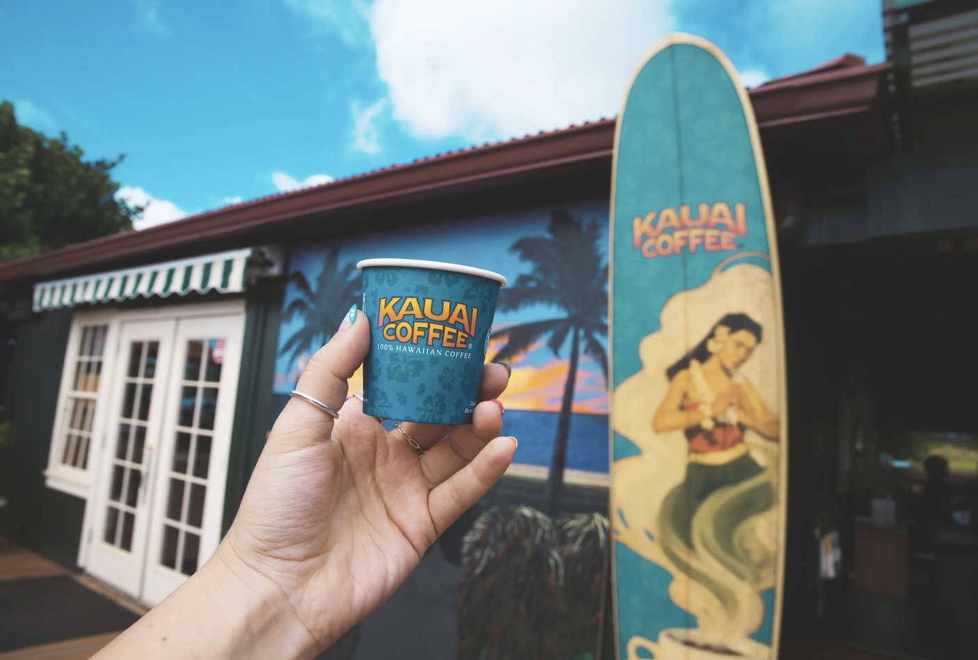 Kauai Coffee Estate cup and surfboard sign